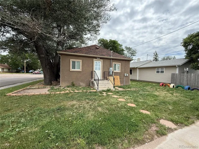 a front view of house with yard and green space