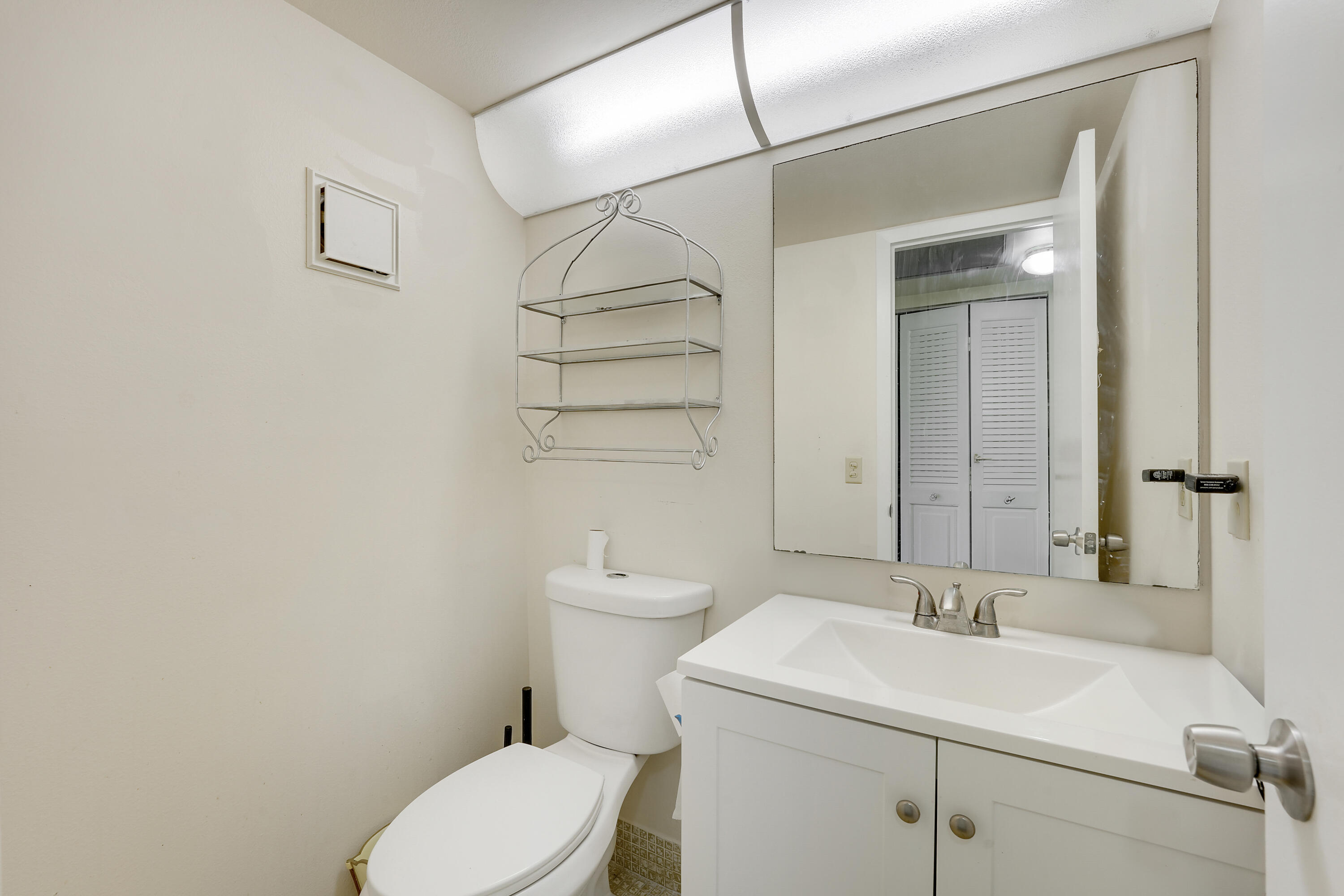 16 Mansfield B Boca Raton, FL 33434 - Photo 9 of 15 a bathroom with a sink a toilet and shower
