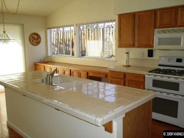 508 Silversmith Place Reno, NV 89511 - Photo 3 of 9 a kitchen with a sink a stove and cabinets