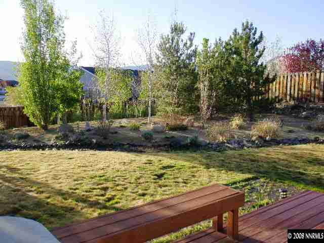 508 Silversmith Place Reno, NV 89511 - Photo 9 of 9 a view of a lake with a bench and trees around