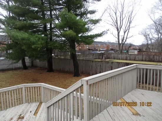 a view of a roof deck with wooden floor and fence