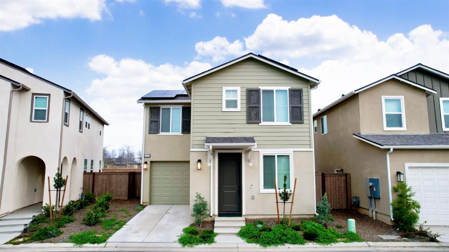 4163 Vincent Road Madera, CA 93636 - Photo 1 of 17 a front view of a house with garden