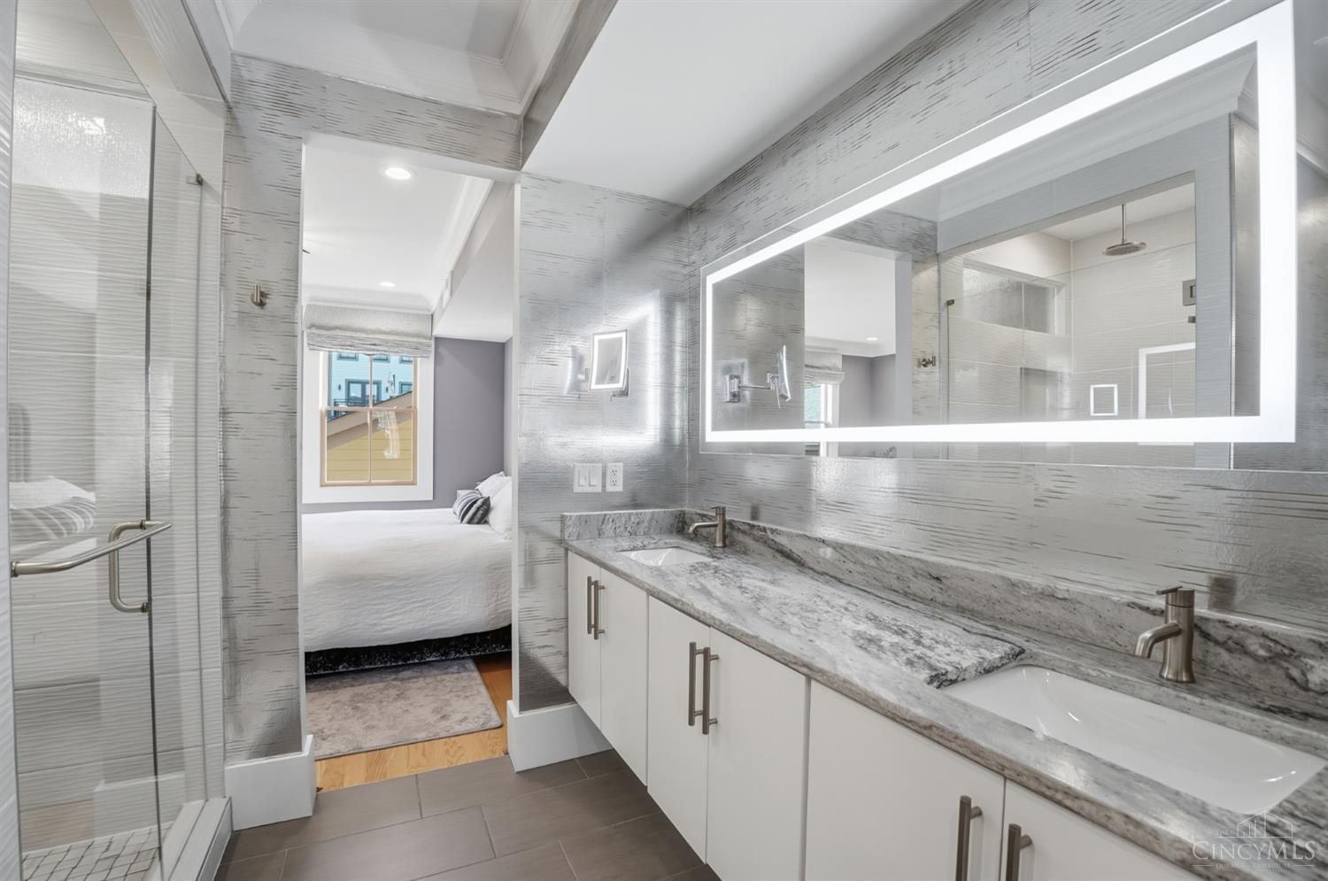1338 Spring Street Cincinnati, OH 45202 - Photo 20 of 46 The owners installed an electric mirror and bidet in the primary bathroom which boasts dual vanities.