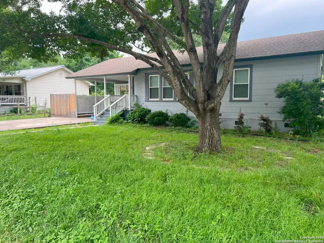 a front view of a house with a yard and porch