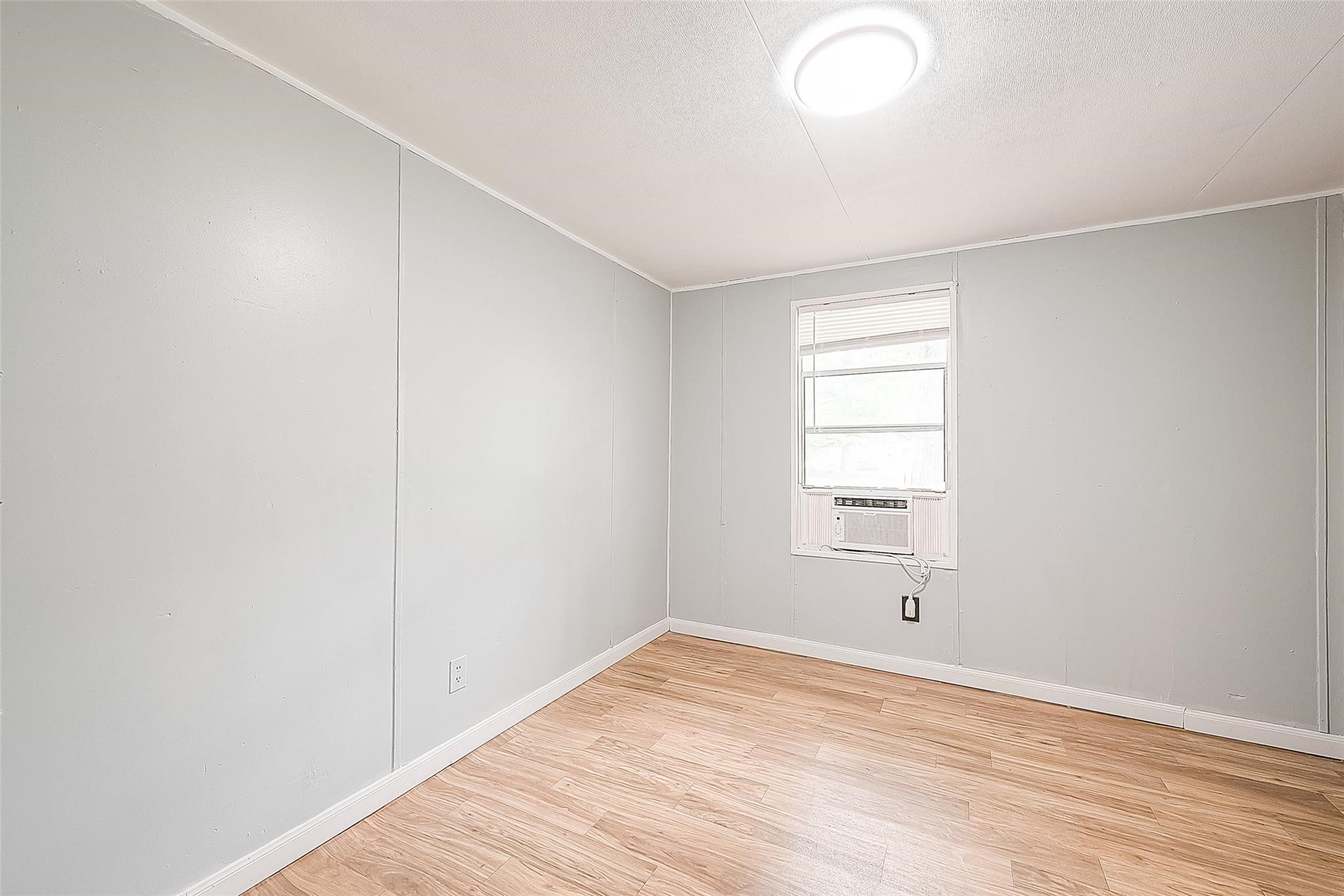 17536 White Oak Orchard Conroe, TX 77306 - Photo 16 of 24 an empty room with wooden floor and windows