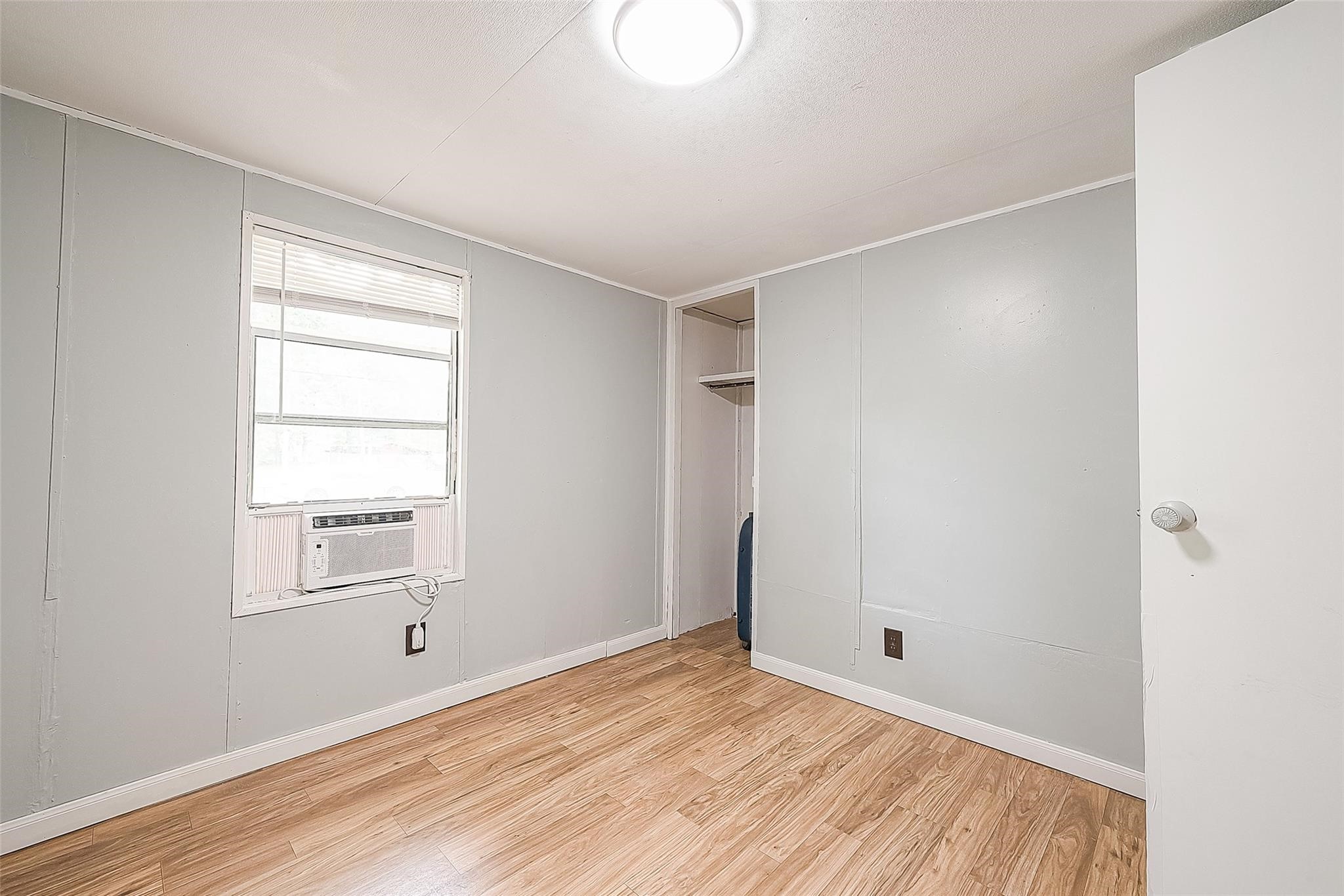 17536 White Oak Orchard Conroe, TX 77306 - Photo 17 of 24 a view of an empty room with wooden floor and a window