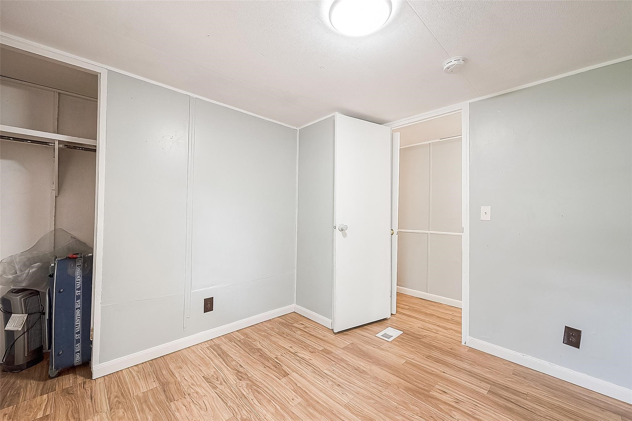 17536 White Oak Orchard Conroe, TX 77306 - Photo 18 of 24 a view of an empty room with wooden floor and a fireplace
