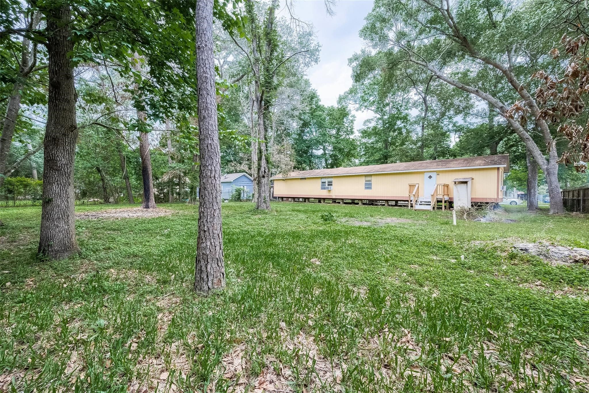 17536 White Oak Orchard Conroe, TX 77306 - Photo 22 of 24 a view of a house with a yard and trees