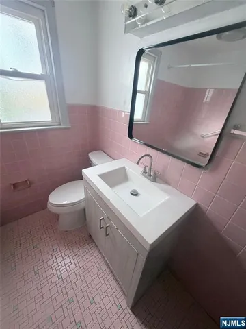 a bathroom with a sink toilet and mirror