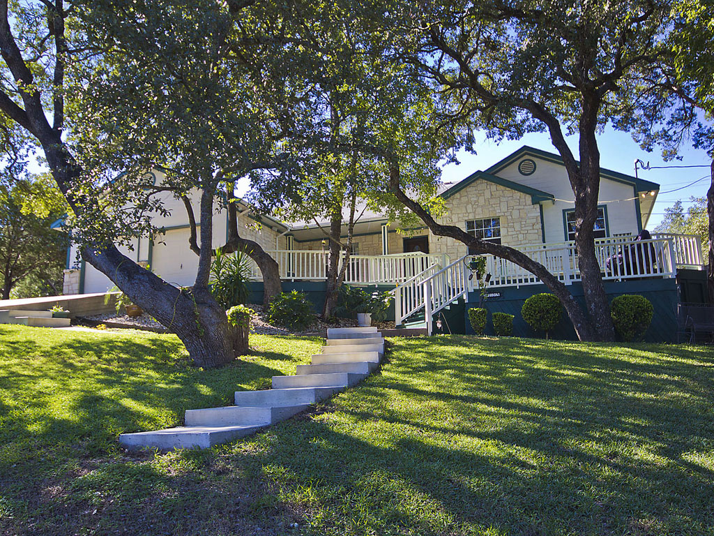 a front view of a house with a yard table and chairs