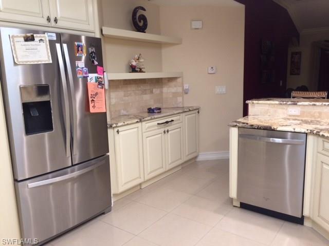3906 14th Street Southwest Lehigh Acres, FL 33976 - Photo 12 of 25 a kitchen with stainless steel appliances granite countertop a refrigerator and a stove