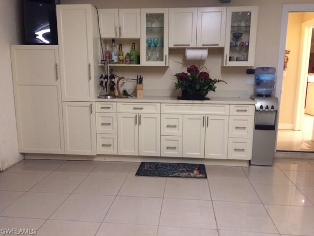 3906 14th Street Southwest Lehigh Acres, FL 33976 - Photo 15 of 25 a kitchen with cabinets and window