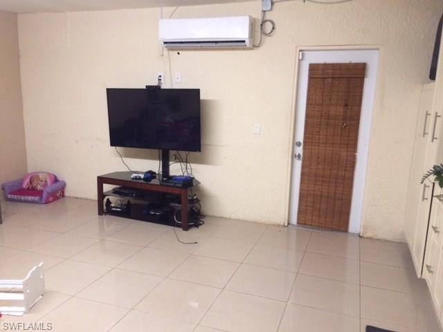 3906 14th Street Southwest Lehigh Acres, FL 33976 - Photo 16 of 25 a room with a cabinet and a mirror