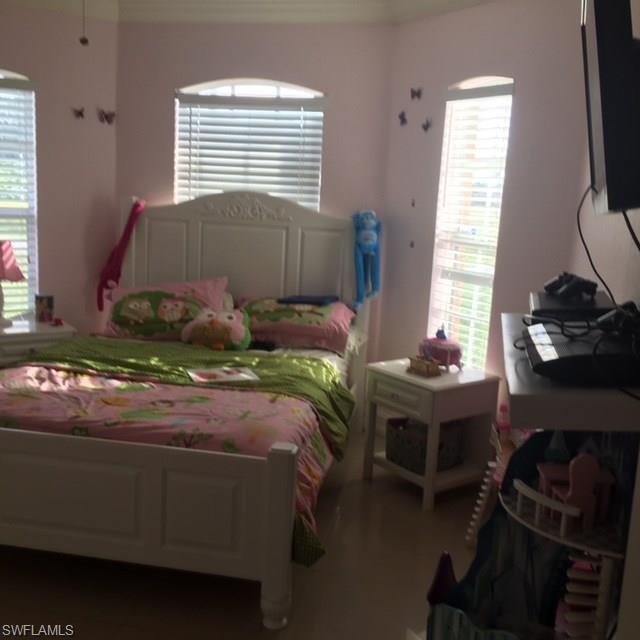 3906 14th Street Southwest Lehigh Acres, FL 33976 - Photo 25 of 25 a bedroom with a bed and a window
