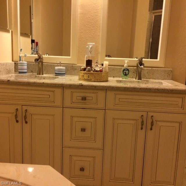 3906 14th Street Southwest Lehigh Acres, FL 33976 - Photo 4 of 25 a bathroom with a sink and a mirror