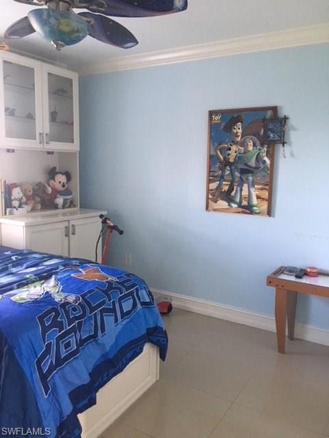 3906 14th Street Southwest Lehigh Acres, FL 33976 - Photo 6 of 25 a bedroom with a bed and a painting on the wall