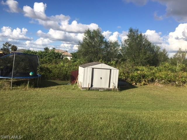 3906 14th Street Southwest Lehigh Acres, FL 33976 - Photo 7 of 25 a house with trees in the background