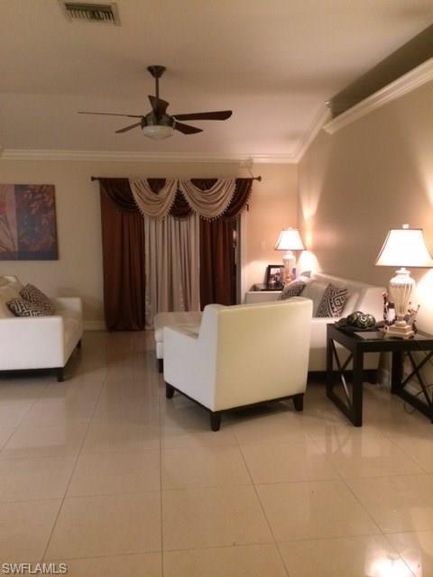 3906 14th Street Southwest Lehigh Acres, FL 33976 - Photo 8 of 25 a living room with furniture and a chandelier