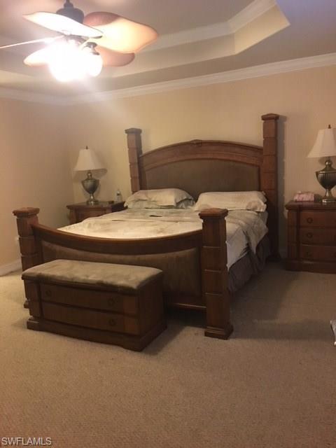 3906 14th Street Southwest Lehigh Acres, FL 33976 - Photo 9 of 25 a bedroom with a bed and lamp with window