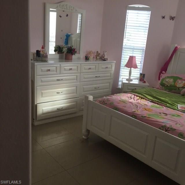 3906 14th Street Southwest Lehigh Acres, FL 33976 - Photo 10 of 25 a view of bedroom with a bed and dresser