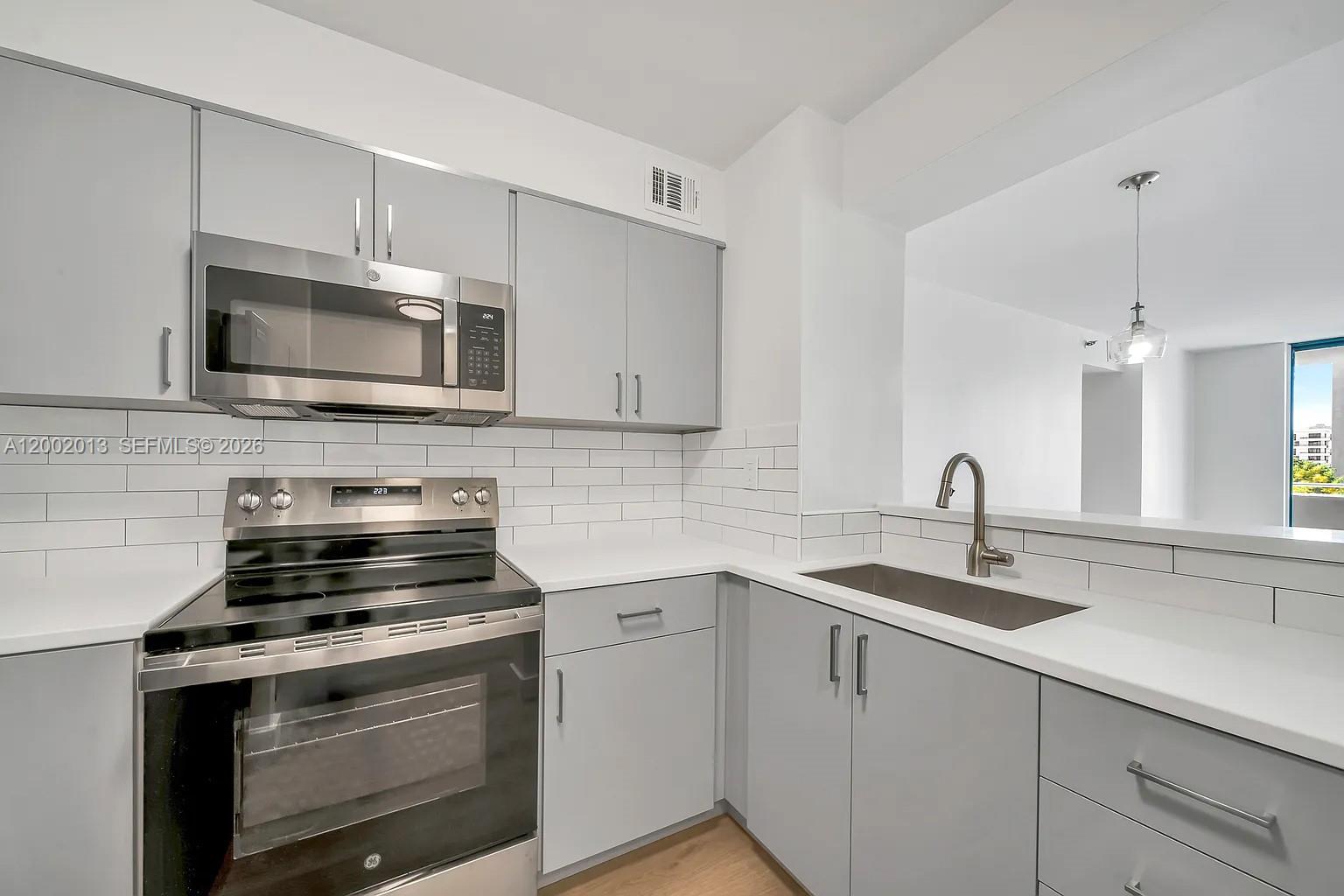 501 Southwest 1st Street, Unit 502 Miami, FL 33130 - Photo 1 of 24 a kitchen with stainless steel appliances a stove microwave and sink