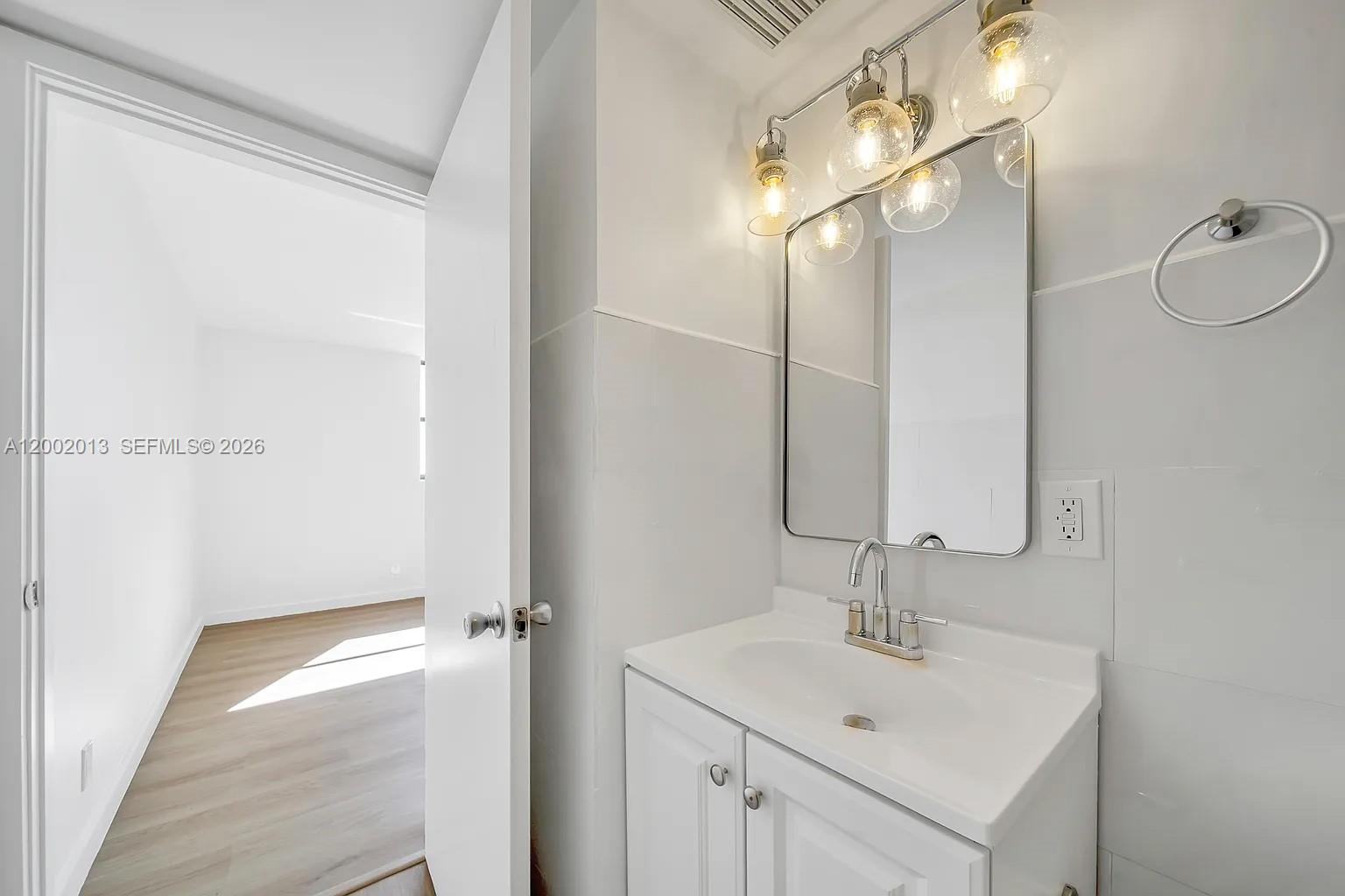 501 Southwest 1st Street, Unit 502 Miami, FL 33130 - Photo 15 of 24 a bathroom with a sink and mirror