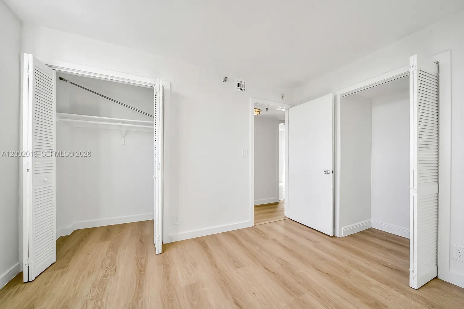 501 Southwest 1st Street, Unit 502 Miami, FL 33130 - Photo 16 of 24 a view of an empty room with wooden floor