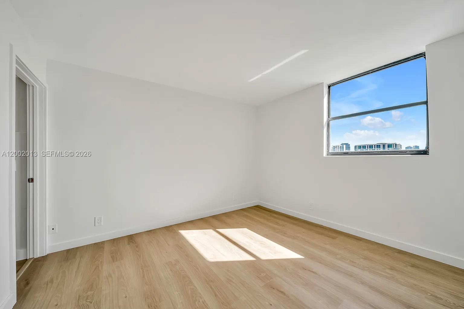 501 Southwest 1st Street, Unit 502 Miami, FL 33130 - Photo 17 of 24 a view of empty room with wooden floor