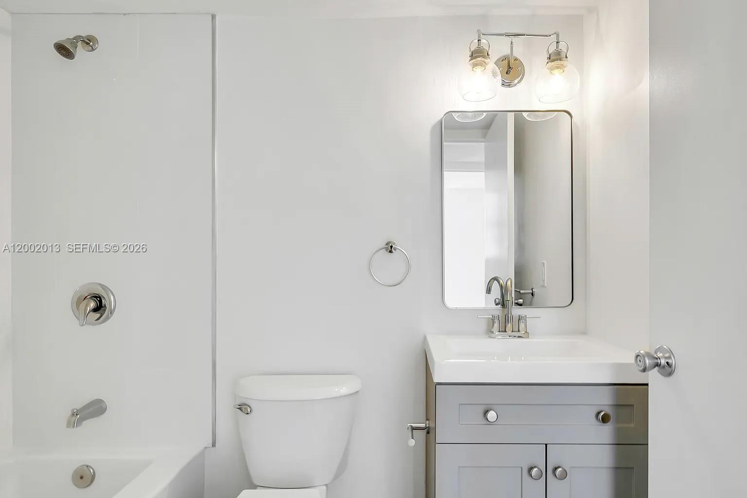 501 Southwest 1st Street, Unit 502 Miami, FL 33130 - Photo 18 of 24 a bathroom with a sink a toilet and shower