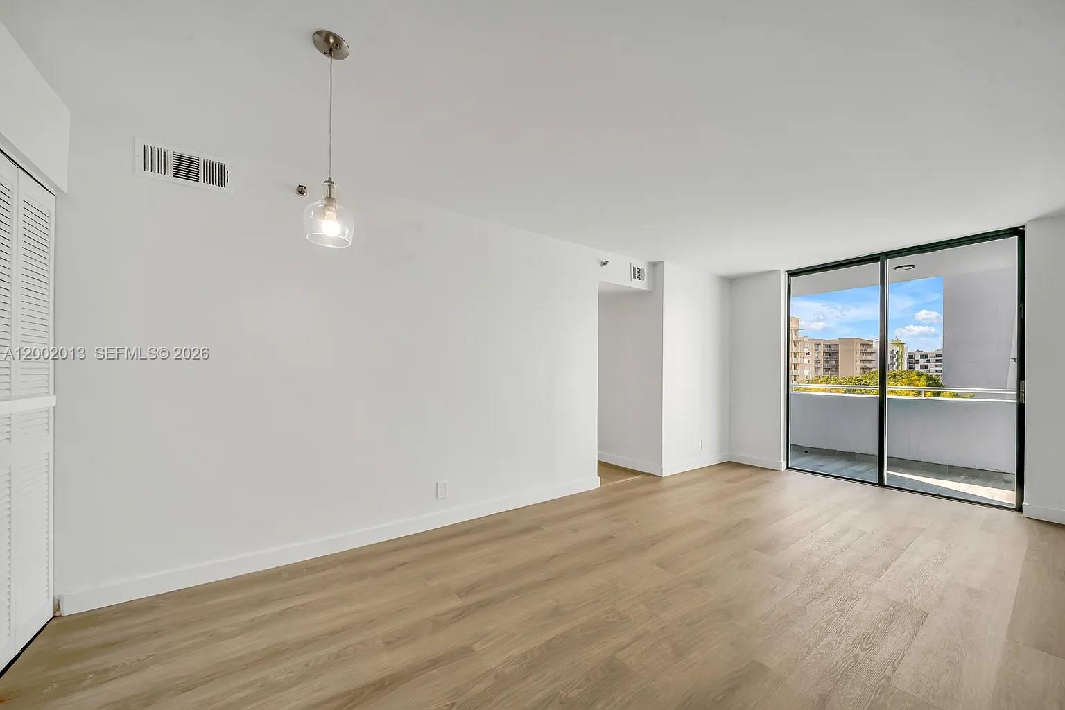 501 Southwest 1st Street, Unit 502 Miami, FL 33130 - Photo 2 of 24 a view of an empty room with glass door