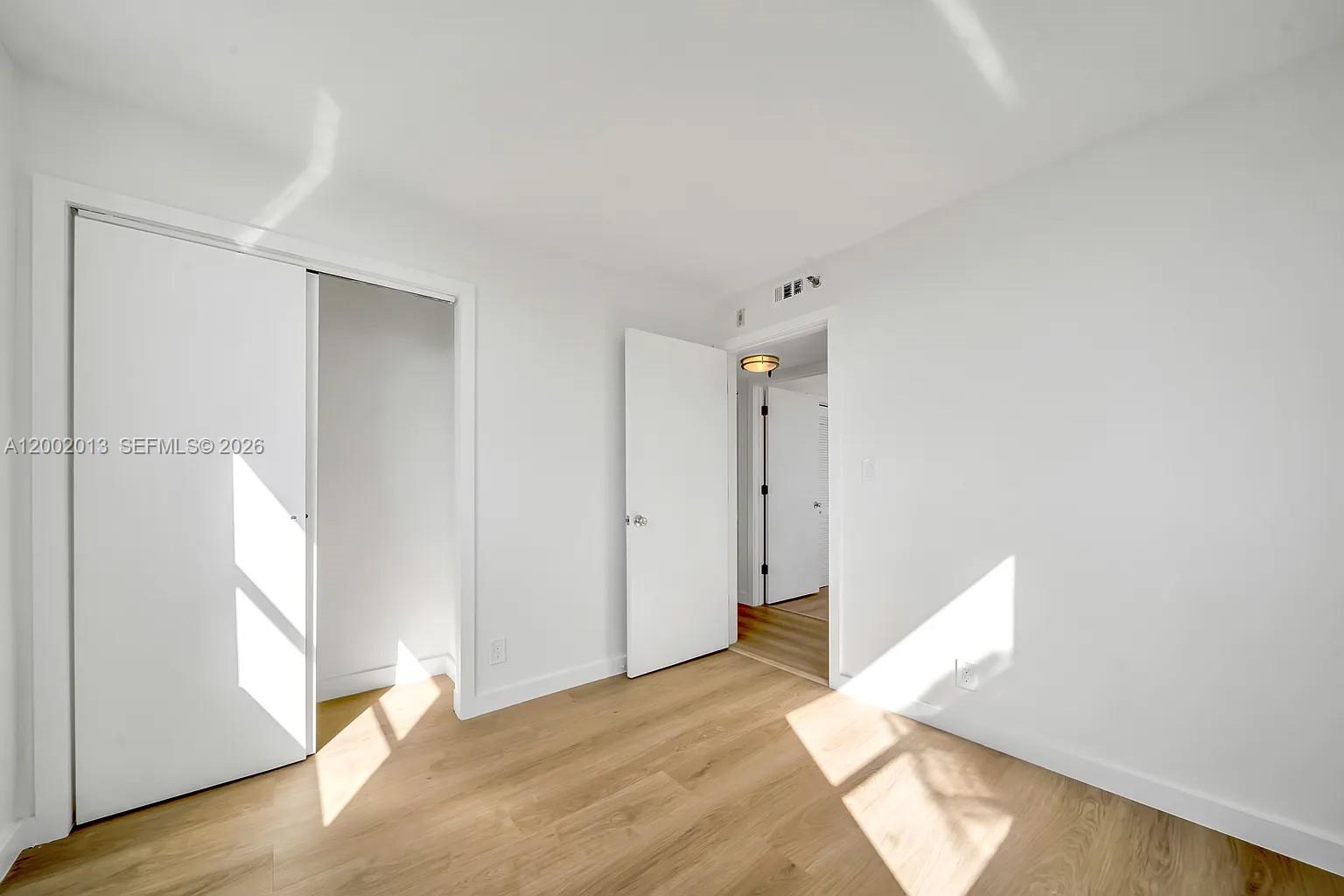 501 Southwest 1st Street, Unit 502 Miami, FL 33130 - Photo 22 of 24 a view of a room with wooden floor and window