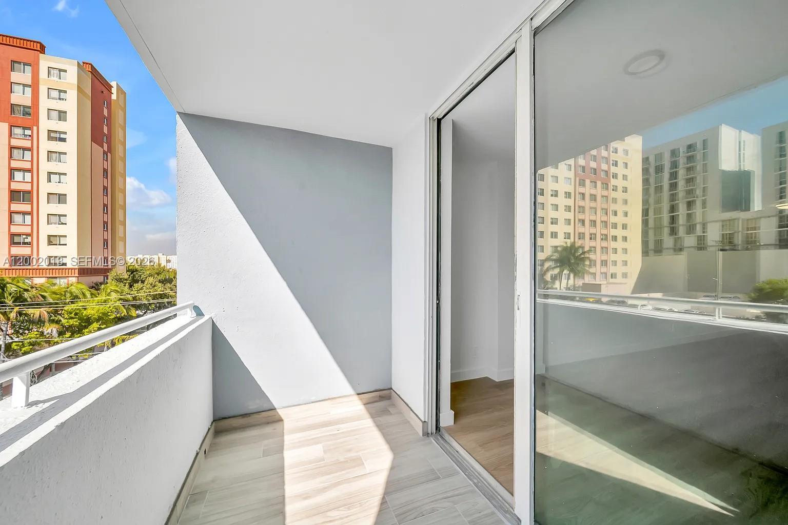 501 Southwest 1st Street, Unit 502 Miami, FL 33130 - Photo 23 of 24 a view of balcony with wooden floor and door