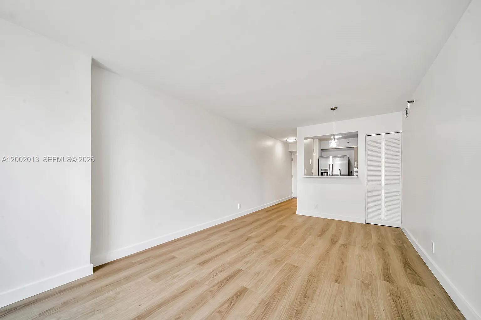 501 Southwest 1st Street, Unit 502 Miami, FL 33130 - Photo 4 of 24 a view of empty room with wooden floor