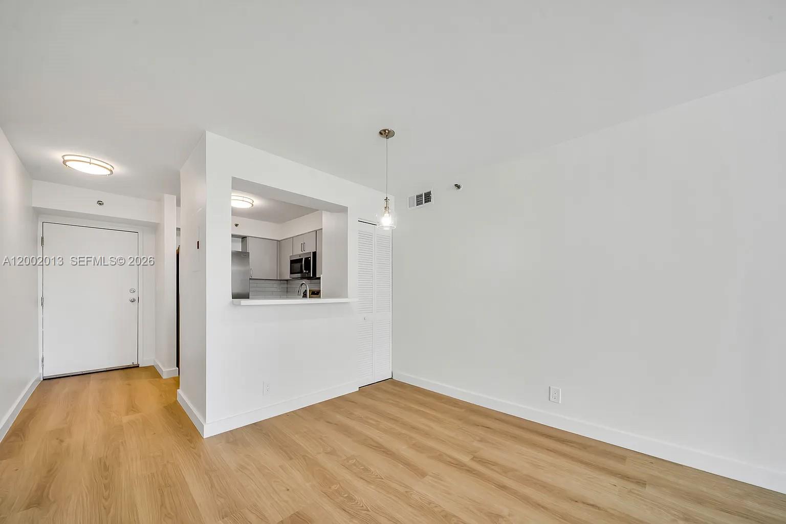 501 Southwest 1st Street, Unit 502 Miami, FL 33130 - Photo 5 of 24 a view of a room with wooden floor and a sink