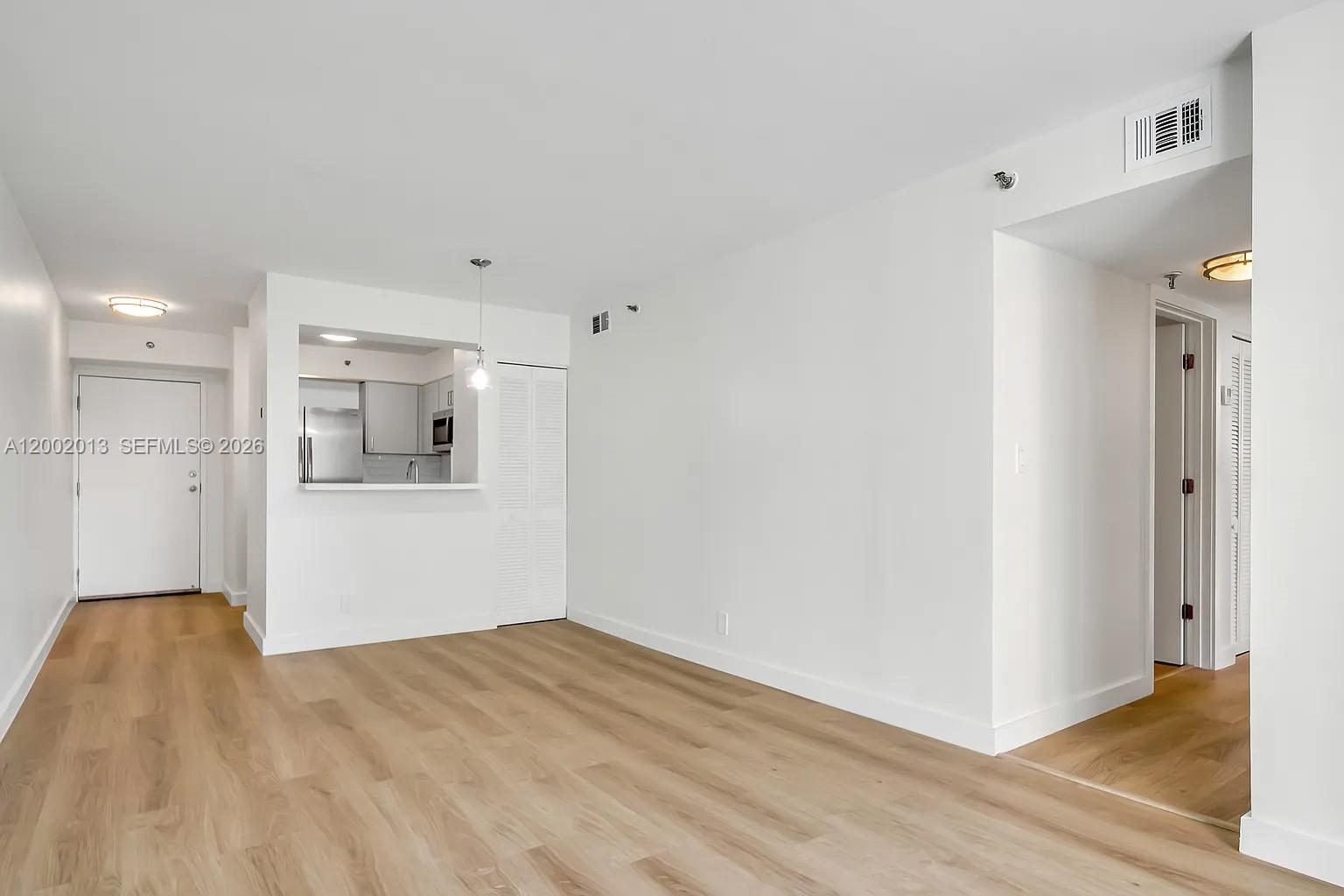 501 Southwest 1st Street, Unit 502 Miami, FL 33130 - Photo 6 of 24 a view of a kitchen with wooden floor and a sink
