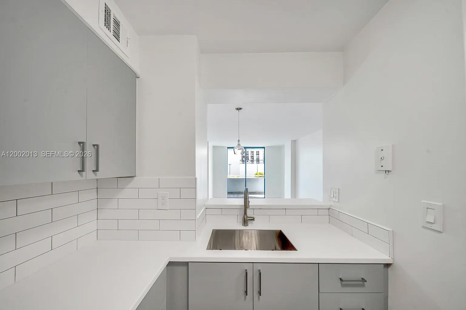 501 Southwest 1st Street, Unit 502 Miami, FL 33130 - Photo 9 of 24 a kitchen with a sink and a window