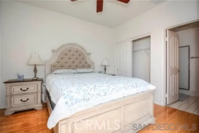 a bedroom with a bed and a tv on the dresser