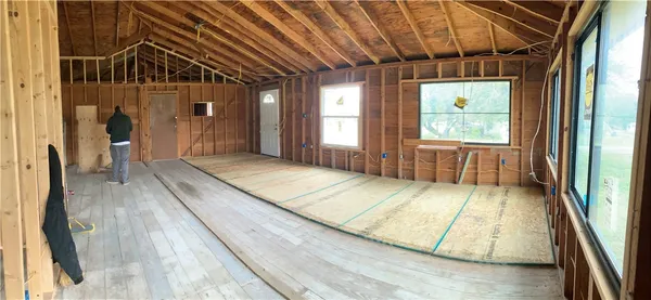 a view of a room with wooden floor and windows
