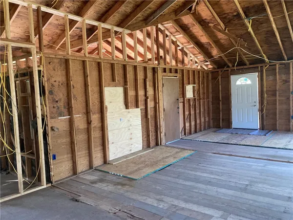 a view of an entryway with wooden floor