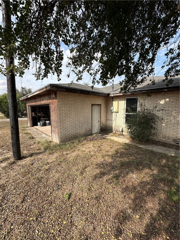 127 Lake Street Mathis, TX 78368 - Photo 4 of 33 a backyard of a house with large trees and covered by side of it
