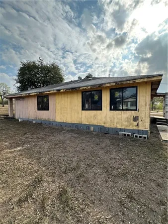 a view of a backyard with table and chairs