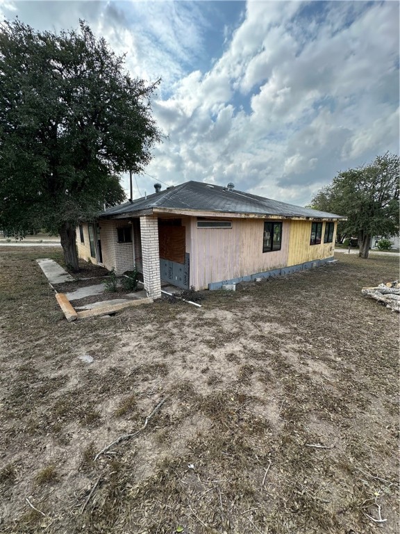 127 Lake Street Mathis, TX 78368 - Photo 10 of 33 a view of a backyard with plants and large tree