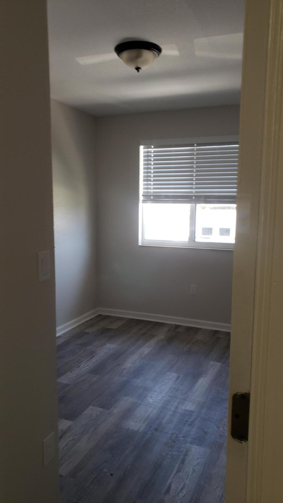 14040 Northeast 2nd Avenue Miami, FL 33161 - Photo 12 of 16 an empty room with a empty space and windows