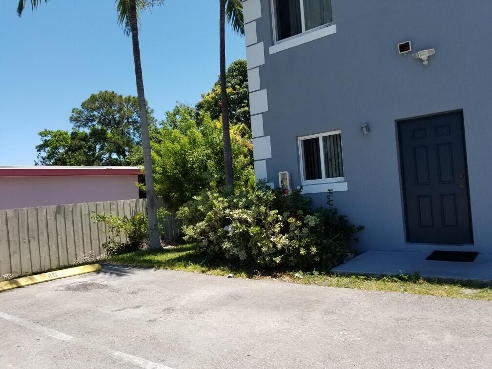 14040 Northeast 2nd Avenue Miami, FL 33161 - Photo 13 of 16 a view of a house with a yard and potted plants