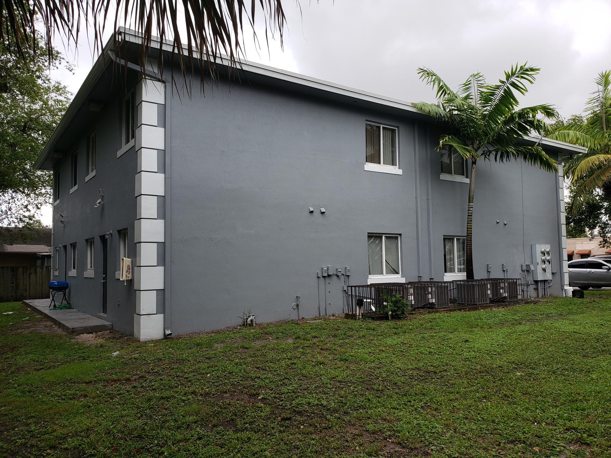 14040 Northeast 2nd Avenue Miami, FL 33161 - Photo 15 of 16 a front view of a house with a garden