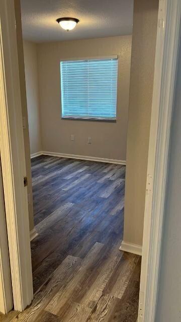 14040 Northeast 2nd Avenue Miami, FL 33161 - Photo 4 of 16 a view of an empty room with wooden floor and a window