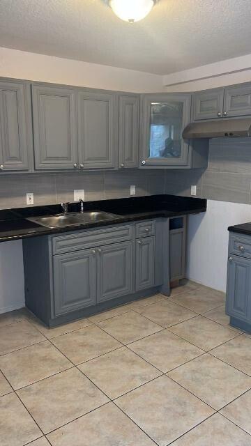 14040 Northeast 2nd Avenue Miami, FL 33161 - Photo 6 of 16 a kitchen with a sink and cabinets
