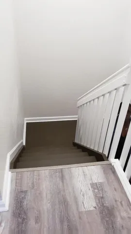 a white toilet sitting next to a bathroom sink and vanity