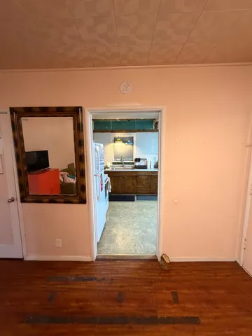 a view of living room with furniture and wooden floor