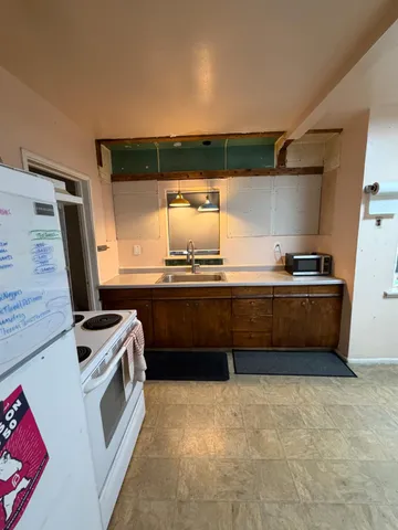 a kitchen with a sink and a stove top oven